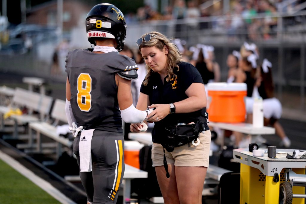 Athletic trainer with a football player
